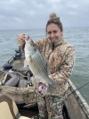 Gabby Hansen with a striped bass hybrid caught at Sooner Lake.