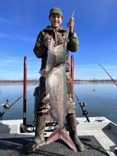Dylan Dickey with a paddlefish caught at Grand Lake.