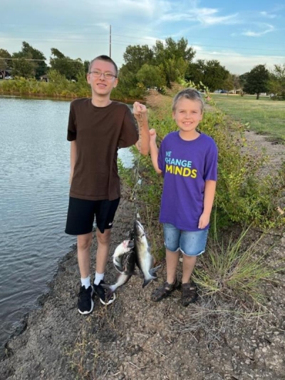 Logan and Landry with their catch from a recent fishing trip with their grandpa, Larry, at Boomer Lake in Stillwater.