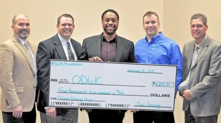 Receiving a $4,200 donation for the Oklahoma Fishing in the Schools Program from Myles Williams (center) of the Paul George Foundation are J.D. Strong, Wildlife Department director; Colin Berg, Education Section supervisor; Daniel Griffith, OKFITS coordinator; and Nels Rodefeld, Information and Education chief.