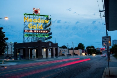 The circa-1939 Meadow Gold sign in Tulsa lights up the sky along Route 66.